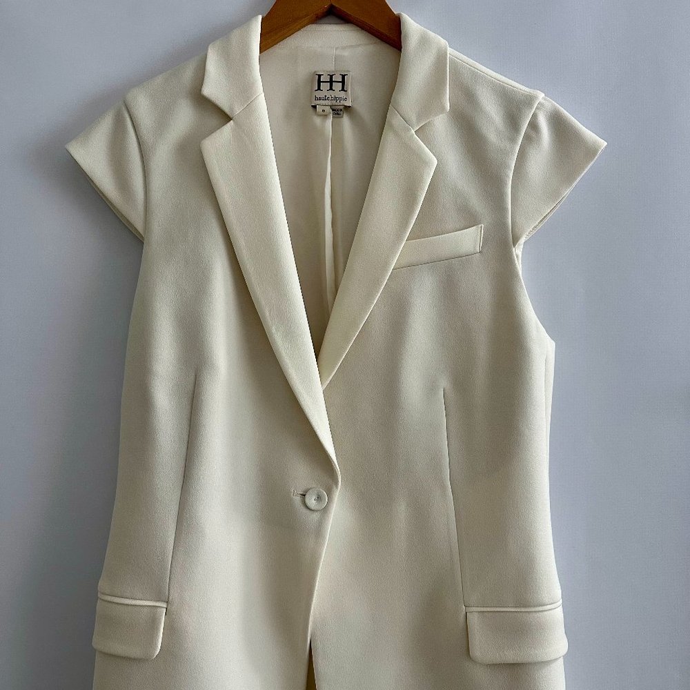 Creme Haute Hippie sleeveless casual vest with dual pockets and button closure a